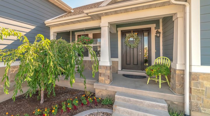 The front porch boasts a decorative concrete surface, offering a blend of charm and durability that greets visitors with a touch of elegance